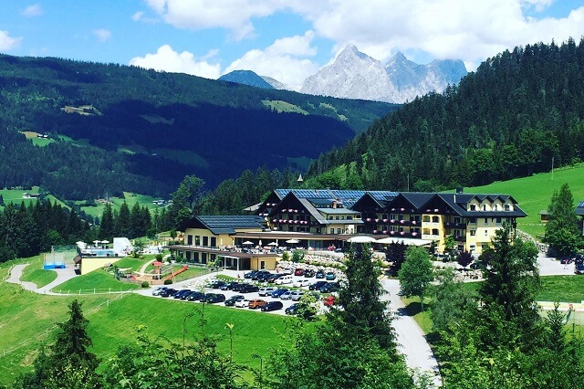 The hotel complex between peaks and lots of greenery. Taken from the hotel's Facebook page