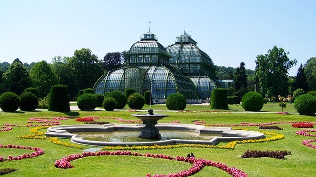 The greenhouse in Schönbrunn is surrounded by manicured gardens in the spring months