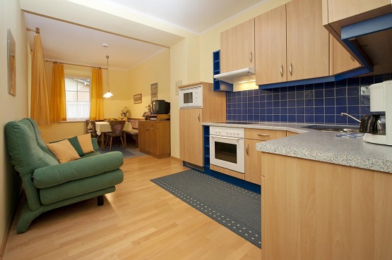 A kitchen and living area in an apartment at Appartements Schwarzvilla