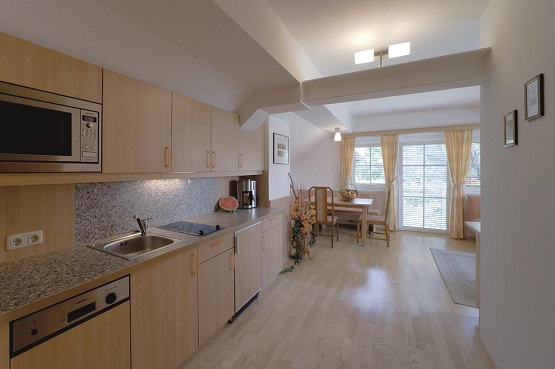 A fully equipped kitchen and dining area at Maltschacher Seewirt