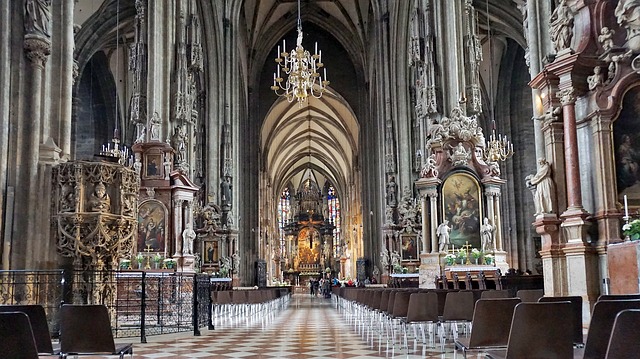 The grand interior of St. Stephen's Cathedral, showing the long nave, columns, and chandeliers