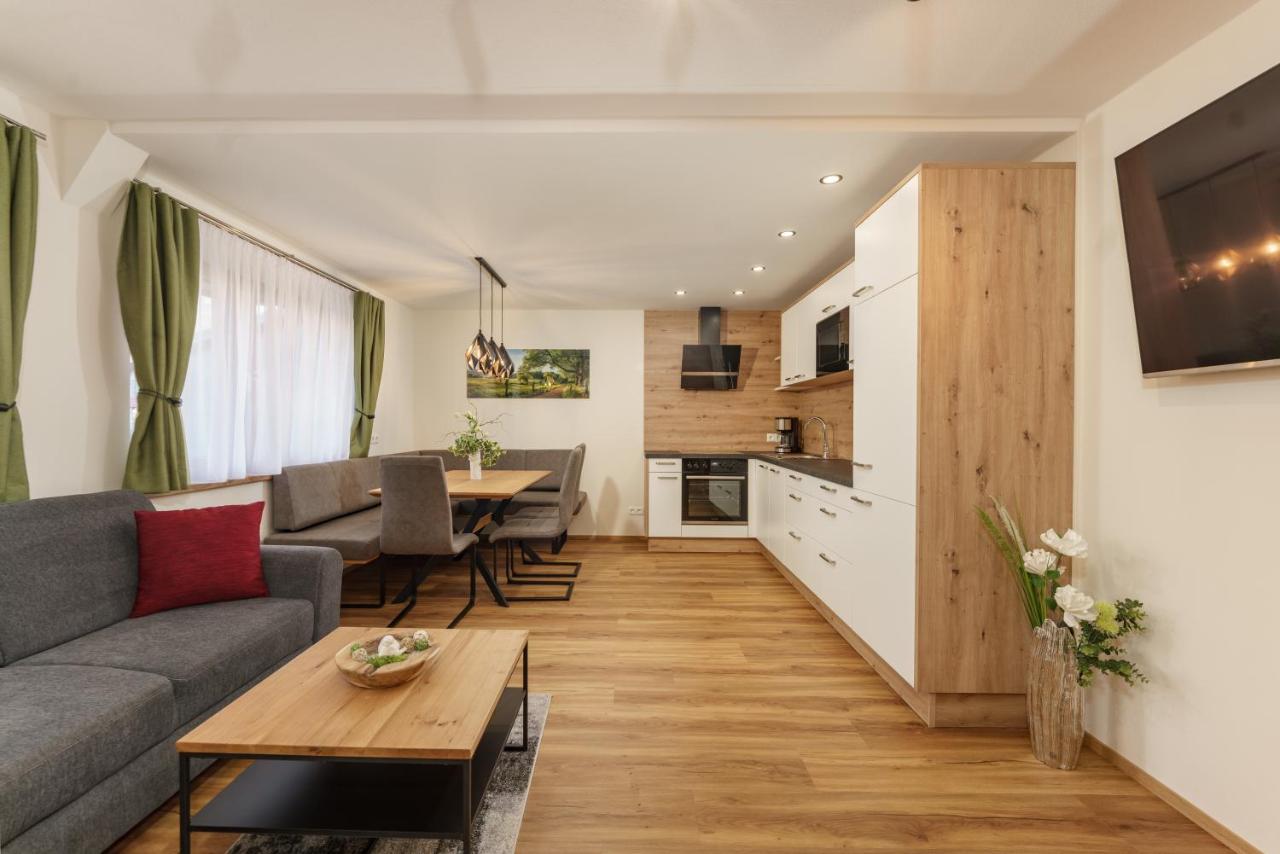 Living room and kitchen in one of the renovated apartments at Stögergut. Courtesy of the Booking website.